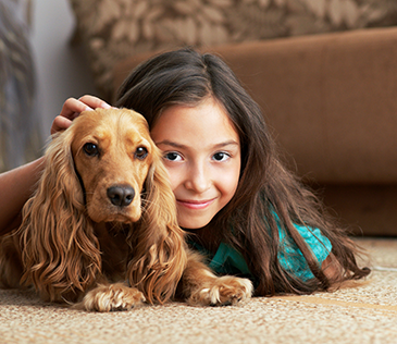 Girl with dog on carpet